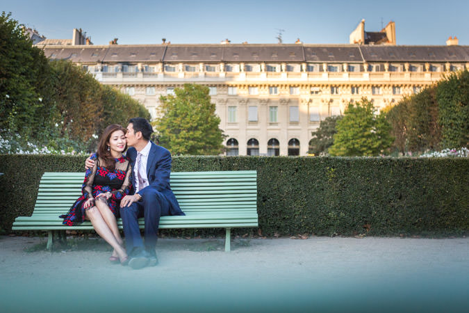 couple posing on a bench on Palais Royal garen in Paris