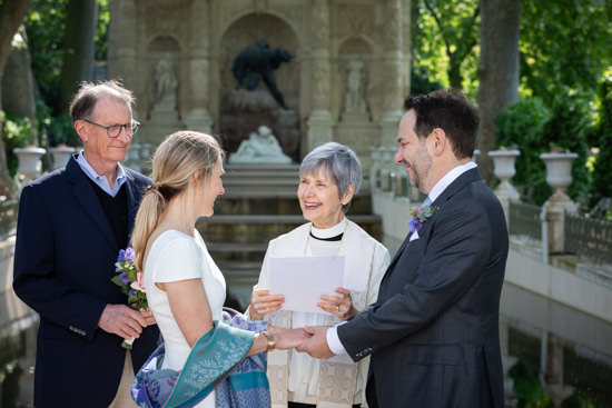 An officiant and the newlyweds during an intimate wedding in Paris