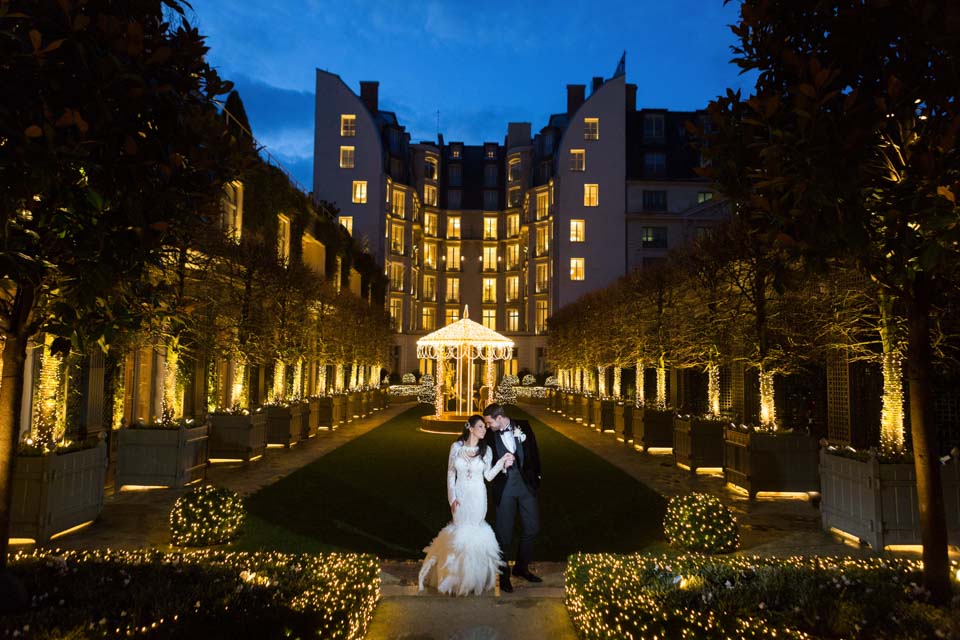 couple posing at Le Ritz Paris by night