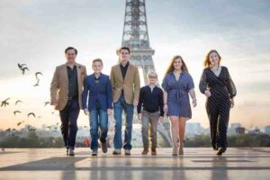 family posing in front of the Eiffel Tower in Paris
