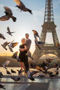 Couple at the Trocadero with flying pigeons