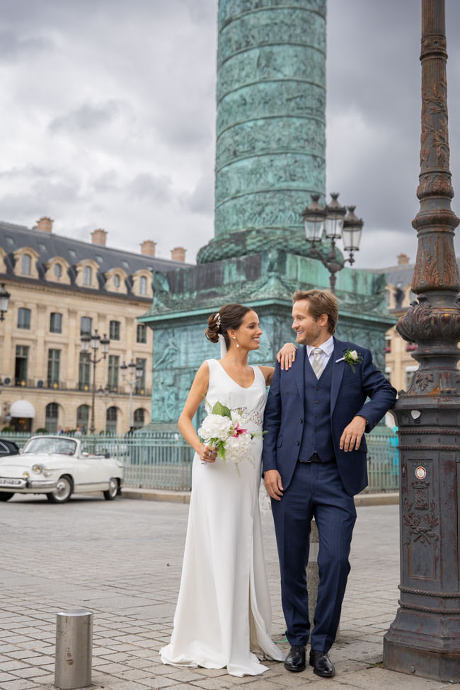A romantic couple posing for their elopement photoshoot in the iconic Place Vendôme, one of the most elegant and luxurious locations in Paris, perfect for timeless wedding portraits in the heart of the city