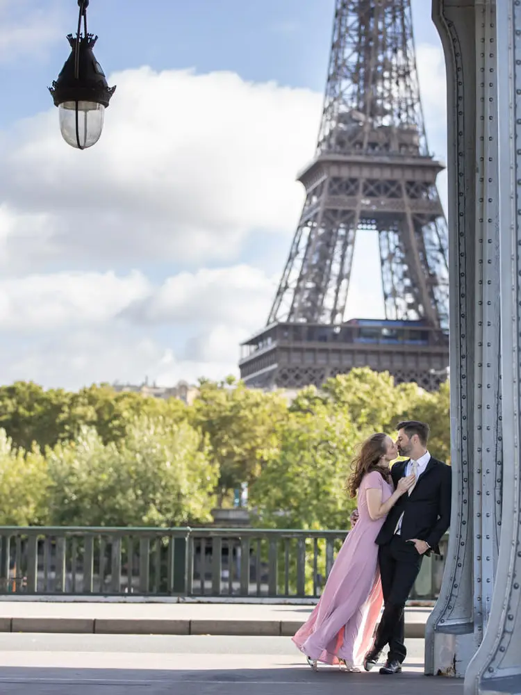 Couple kissing in front of Eiffel Tower